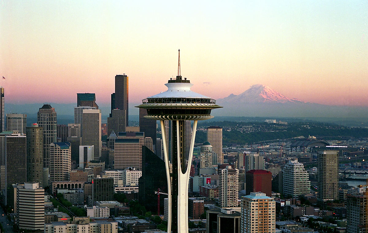 The Space Needle and downtown Seattle skyline with Mount Rainier in the distance at sunset